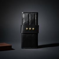 Black roll-up shear wallet with studded latch